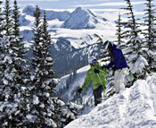 Two people walking in the snowy mountains